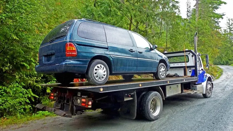 Oshawa flatbed towing a cargo van