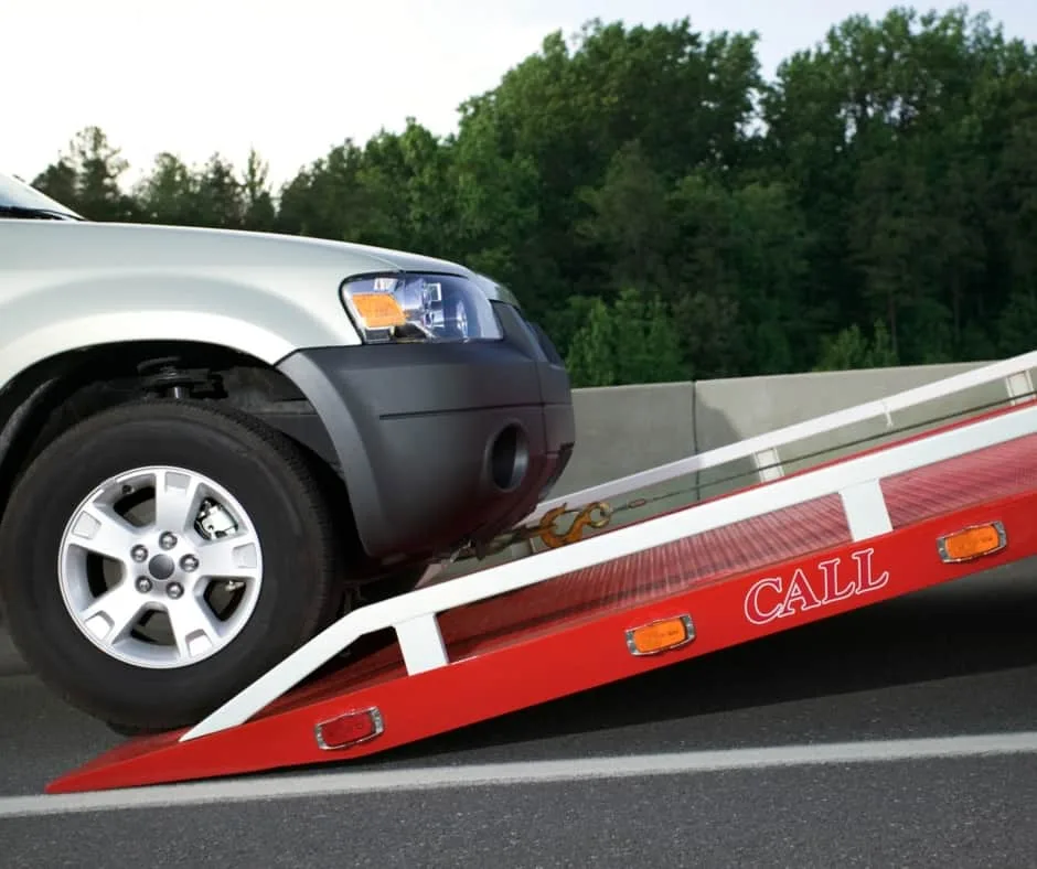 Oshawa tow truck loading a vehicle on a residential street
