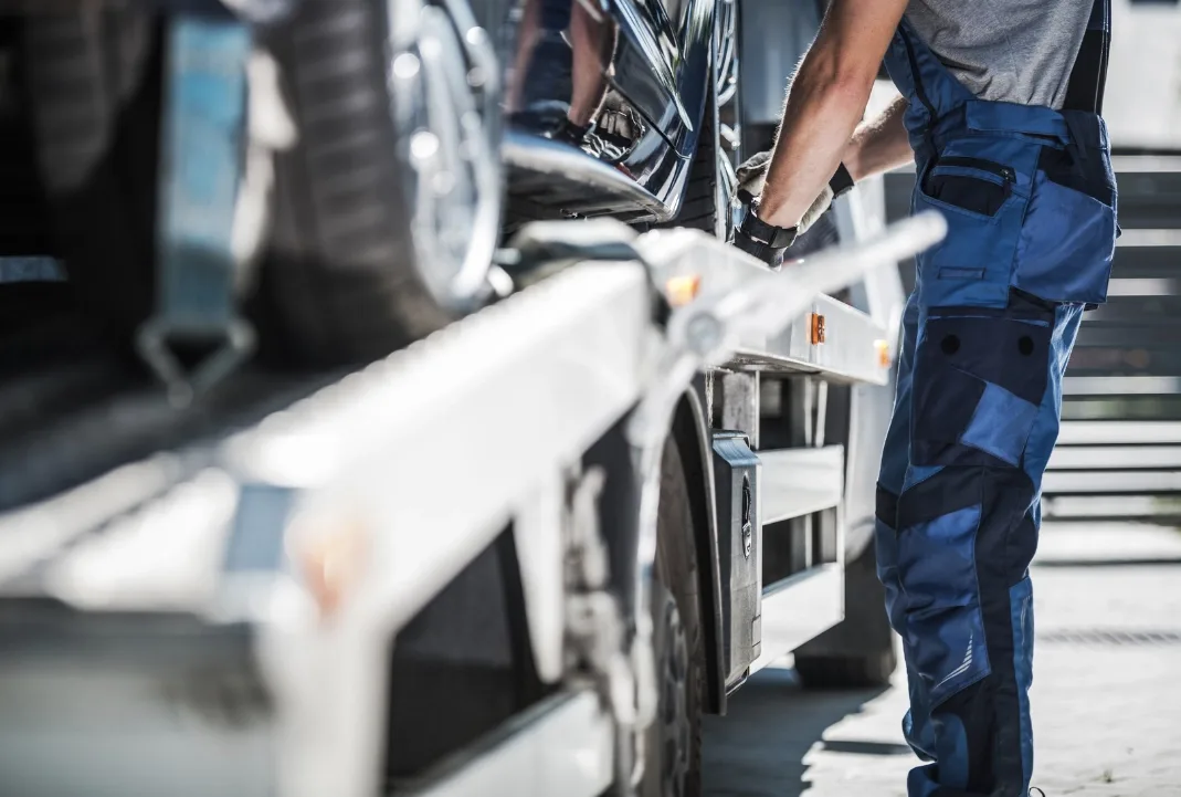 Oshawa tow truck driver loading a car onto a flatbed